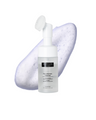 Skincare bottle labeled 'The Ultimate Cleanser' with a foam applicator on a white background
