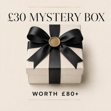 A white gift box tied with a black ribbon and gold seal, centered on a light beige background with the text '£30 MYSTERY BOX' above and 'WORTH £80+' below.