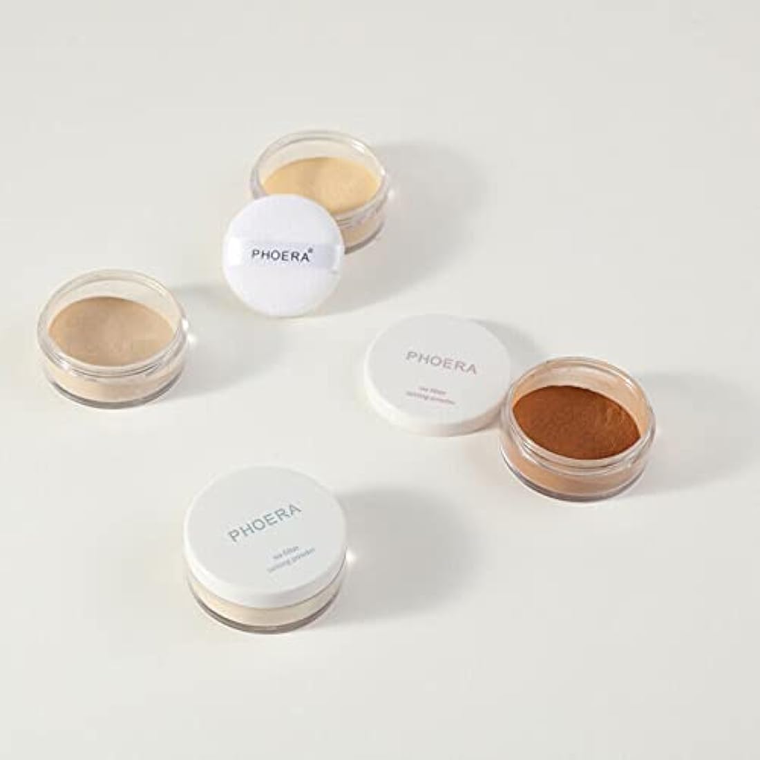 Phoera setting powder with open container showing powder inside, on a white background