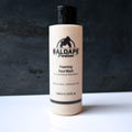 Baldape cleanser bottle on dark background
