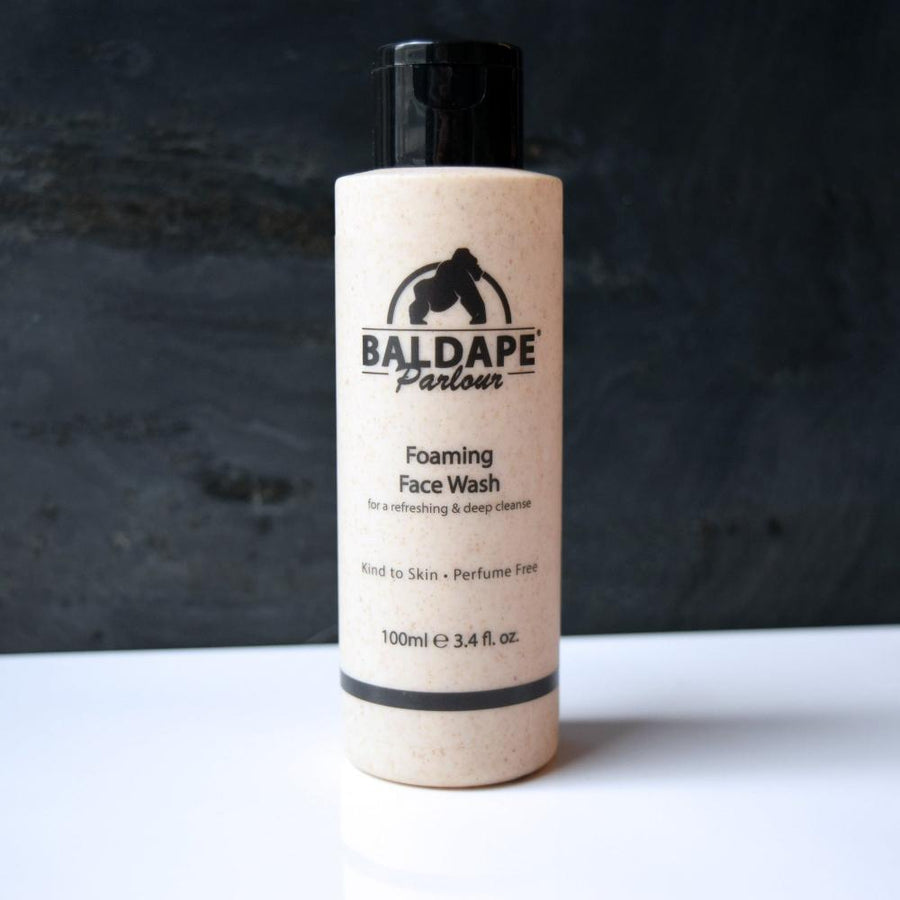 Baldape cleanser bottle on dark background
