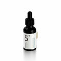 Black dropper bottle with white label on a white background