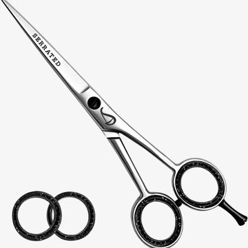 Hair cutting scissors with 'Serrated' text on a white background