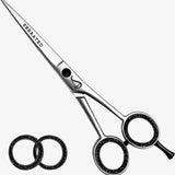 Hair cutting scissors with 'Serrated' text on a white background