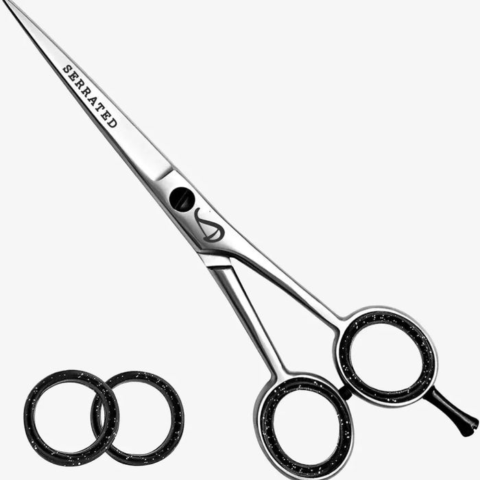 Hair cutting scissors with 'Serrated' text on a white background