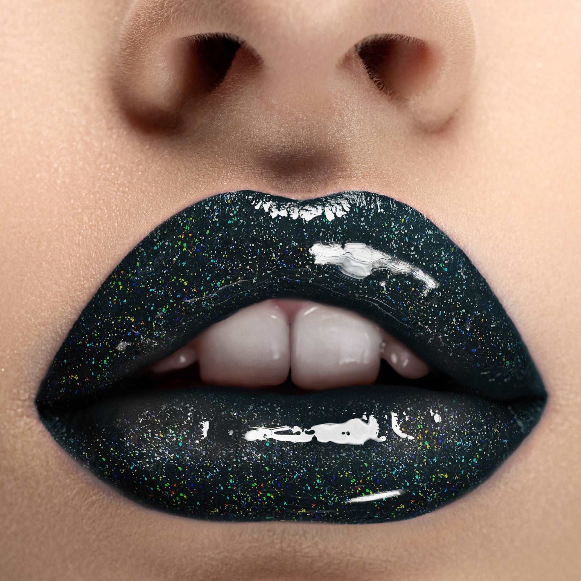 Black holographic glitter lip gloss on lips with multidimensional sparkle, Jolie Beauty So Below shade