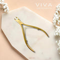 Gold nail clippers on a marble surface with 'VIVA INSTRUMENTS' branding.