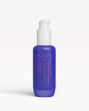 Blue serum bottle with white pump on a light gray background