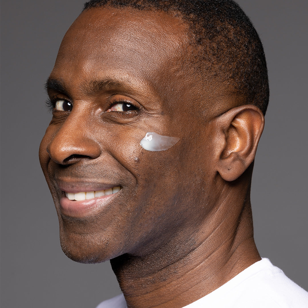 Green bottle of 'Face Award' moisturizer with a white cap on a white background