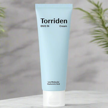 Torriden cream tube on a neutral background with plants