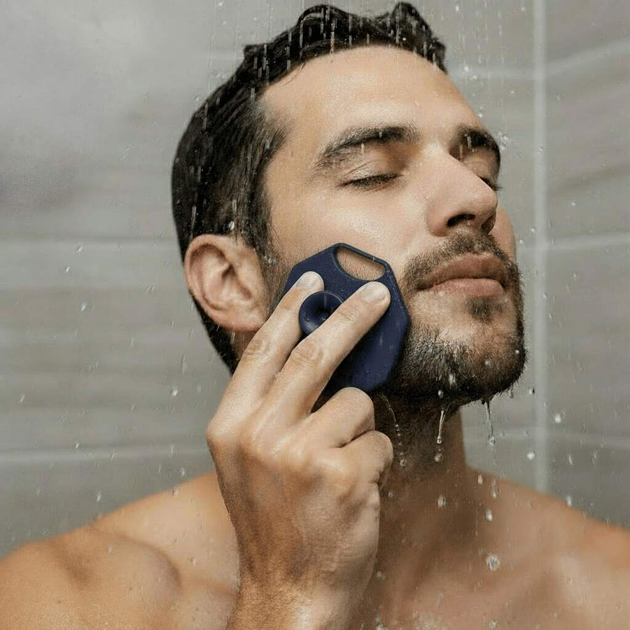 Man using ScrubMeFace Breathtaking Blue facial cleansing brush