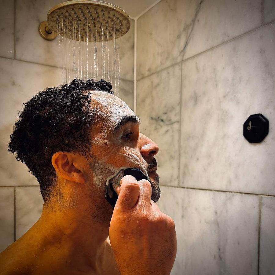 Man using ScrubMeFace Breathtaking Blue during shaving routine