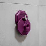 ScrubMeFace Passionate Purple cleansing brush hanging on bathroom tiles