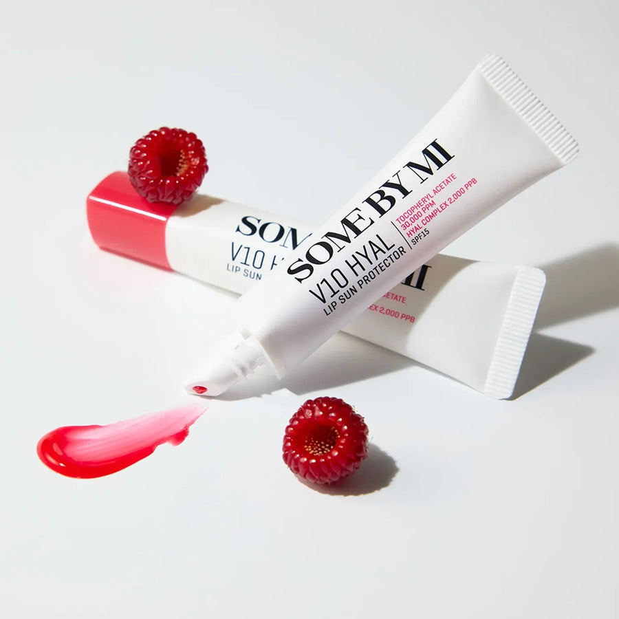 SOME BY MI lip balm and lip sun protector with raspberries on a light background
